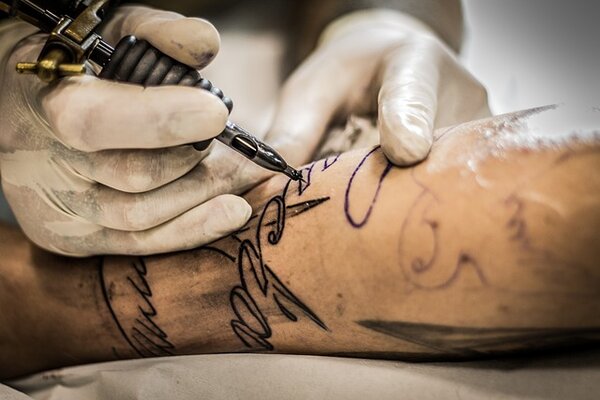 TATTOO REMOVAL, SCARRED OPPORTUNITIES: A DISQUALIFICATION DILEMMA
